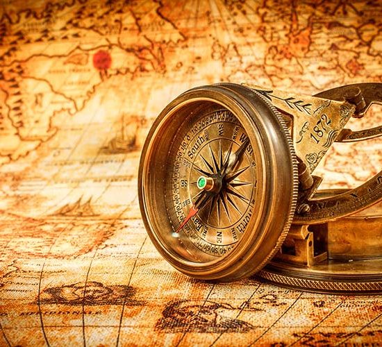 Vintage still life. Vintage compass lies on an ancient world map in 1565.